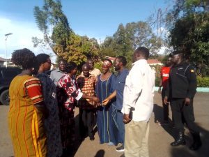 Govonor Kisumu County, Hon Peter Anyang Nyong'o'o greetings Deputy Mayor Gulu City, while Amb. Olara Otunnu and Cheif Justice Owiny Dollo looking at