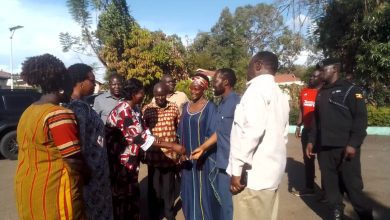 Govonor Kisumu County, Hon Peter Anyang Nyong'o'o greetings Deputy Mayor Gulu City, while Amb. Olara Otunnu and Cheif Justice Owiny Dollo looking at
