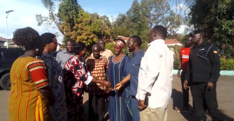 Govonor Kisumu County, Hon Peter Anyang Nyong'o'o greetings Deputy Mayor Gulu City, while Amb. Olara Otunnu and Cheif Justice Owiny Dollo looking at